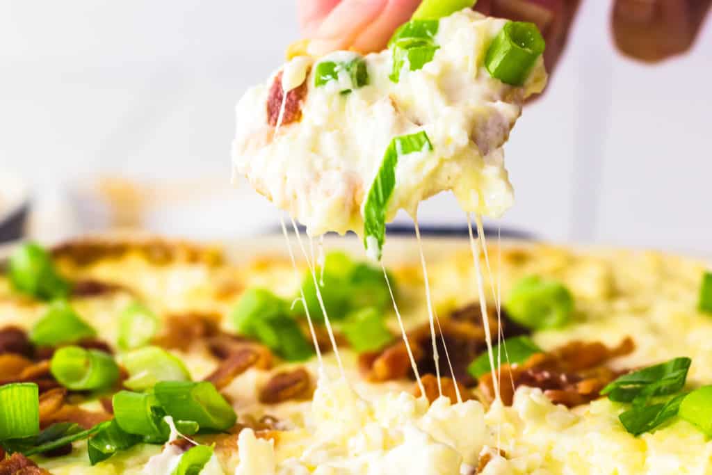 baked bacon cheese dip on a cracker