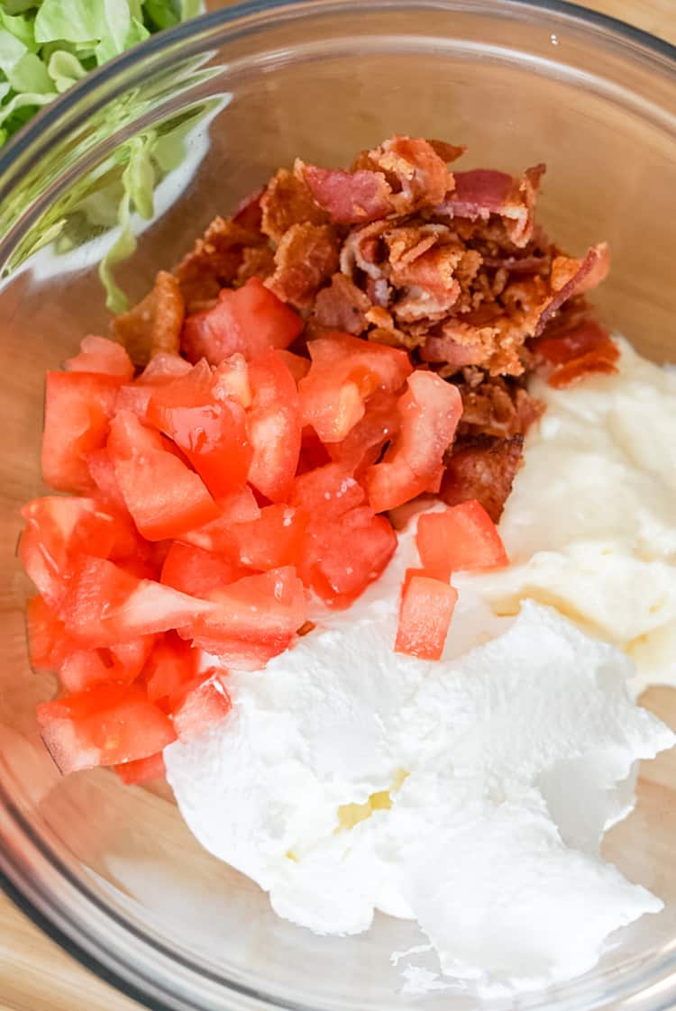 bacon tomato mayo and sour cream in a clear mixing bowl