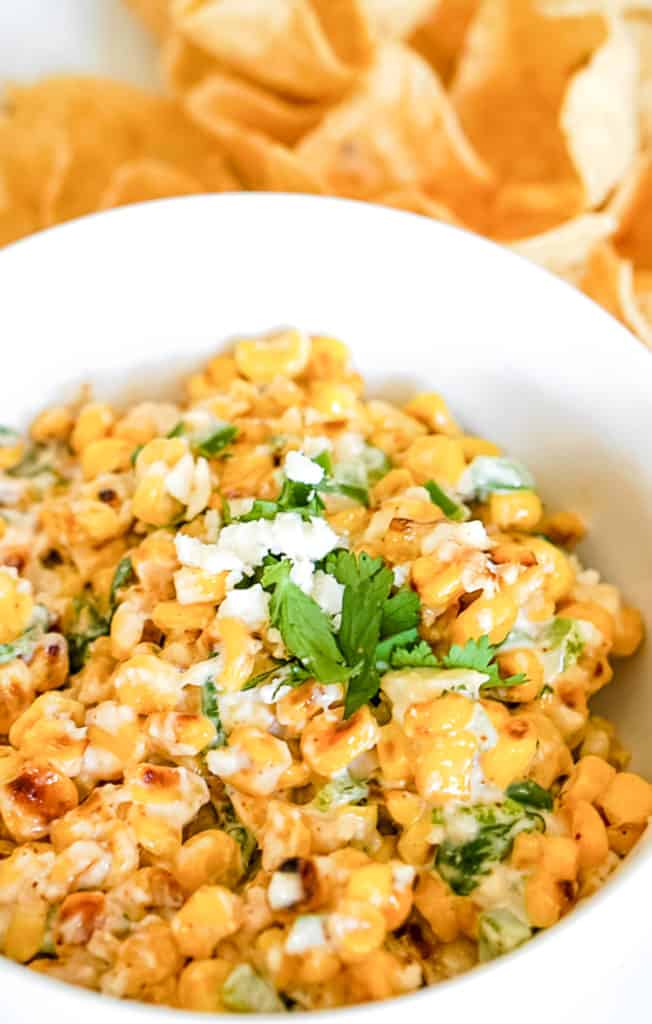 close up photo of elote dip made with corn, mayo, Mexican cheese and spices