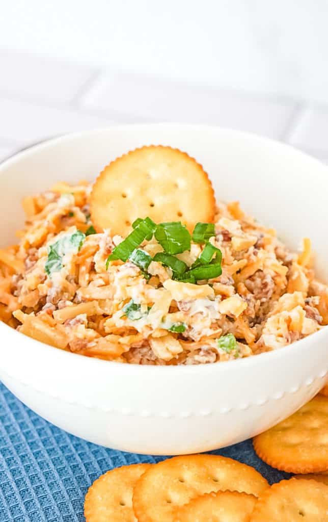 neiman marcus dip aka almond bacon cheese spread in a white bowl with Ritz crackers on the side