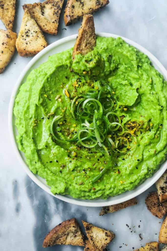 prepared colorful green pea hummus