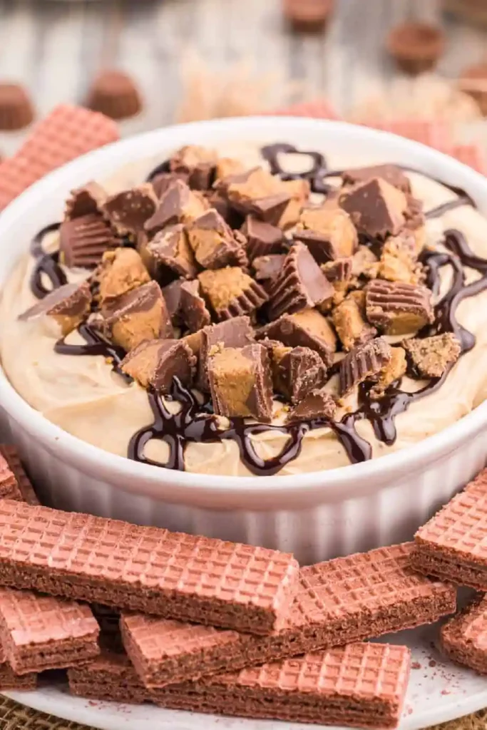 peanut butter cup cheesecake dip with reese's cups on top