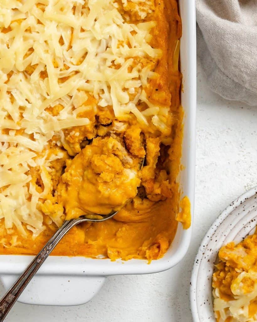 vegan buffalo chicken dip in a casserole dish with a spoon