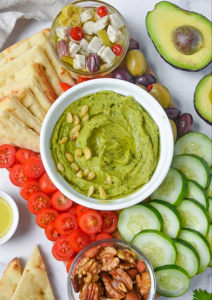 vegan avocado hummus surrounded by veggies