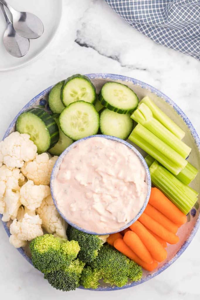 creamy salsa dip in a bowl surrounded by veggies