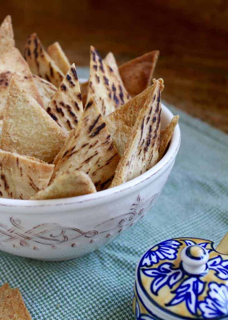 homemade baked garlic pita chips in a bowl