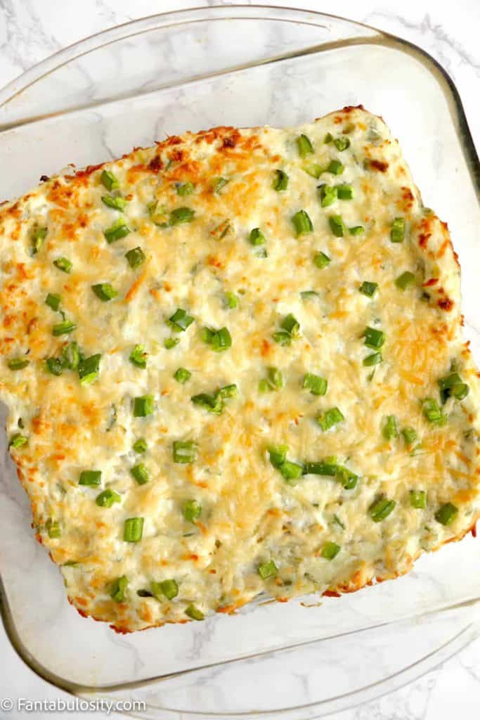overhead photo of jalapeno artichoke dip in a casserole dish 