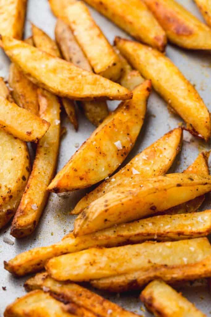 homemade oven baked fries on parchment paper 