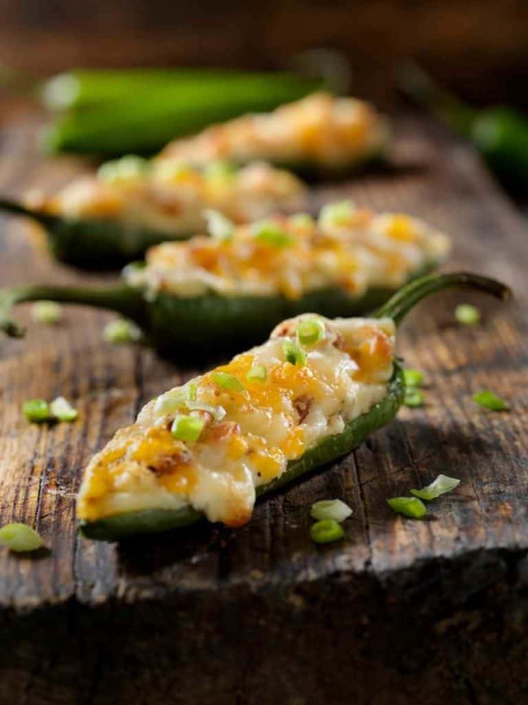 prepared stuffed jalapeno poppers on a cutting board