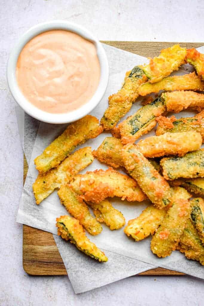 overhead photo of fried zucchini with dipping sauce