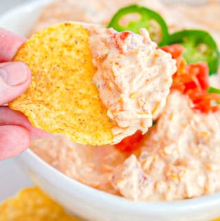 four ingredient taco dip being scooped up with a tortilla chip
