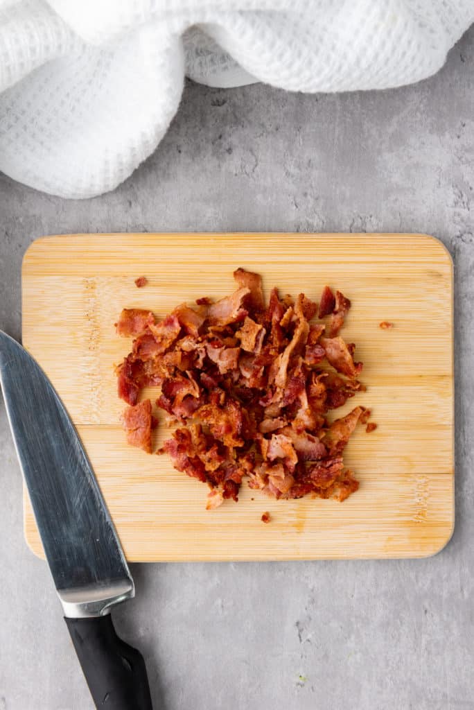 chopped bacon on a wooden cutting board