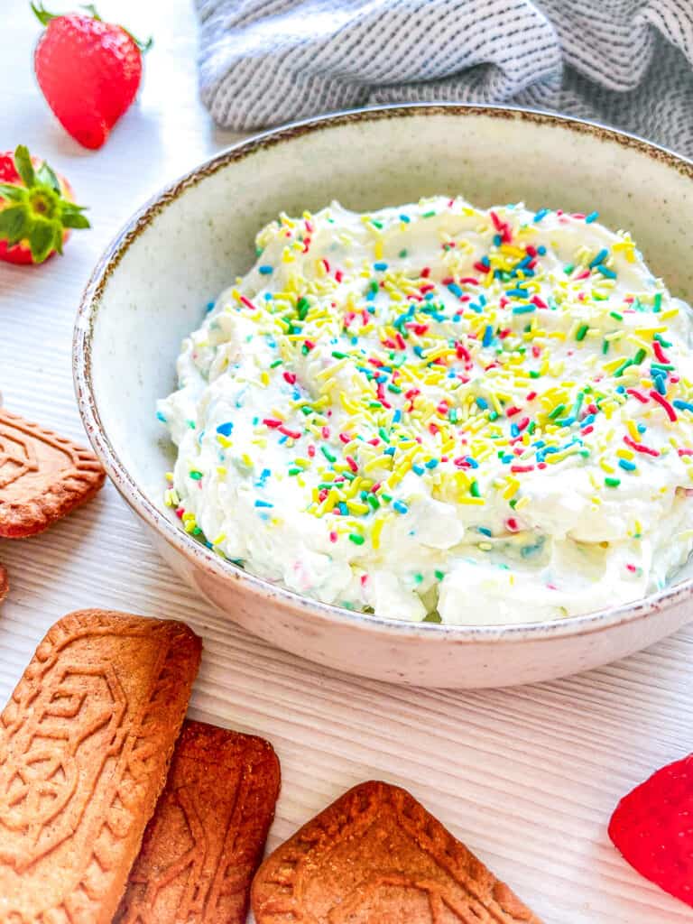 cake batter dip in a bowl with cookies
