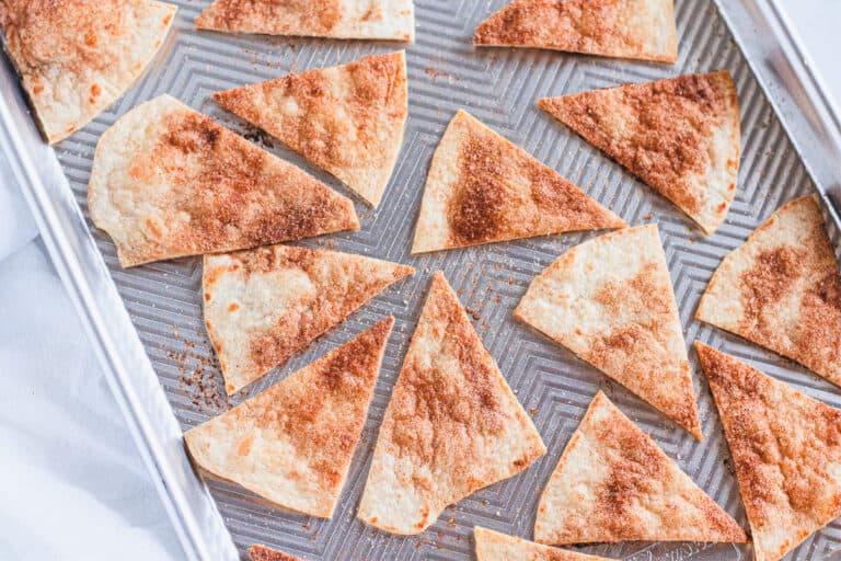 baked cinnamon sugar tortilla chips on a baking sheet