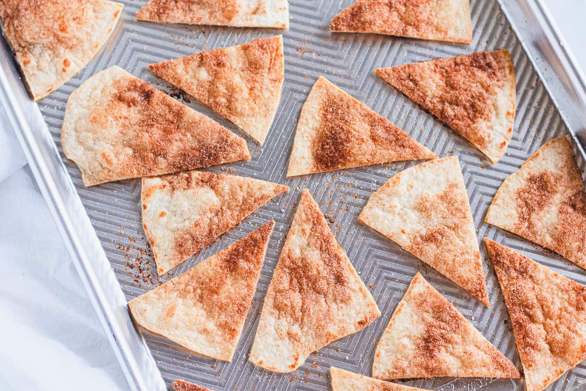baked cinnamon sugar tortilla chips on a baking sheet