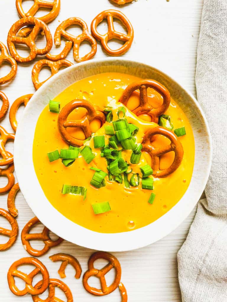 beer cheese dip for pretzels prepared with pretzels on the side for dipping