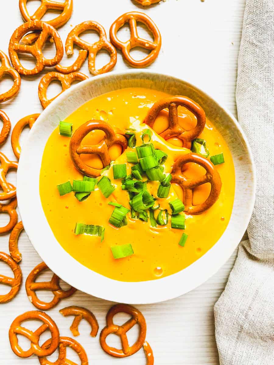 beer cheese dip for pretzels prepared with pretzels on the side for dipping