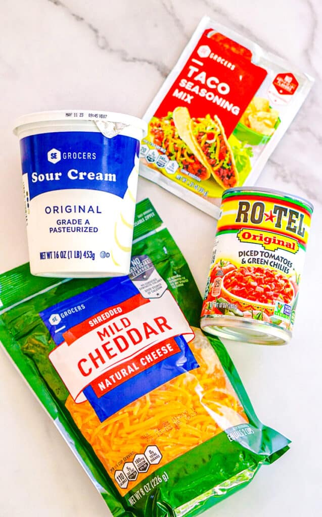 boat dip ingredients include sour cream, cheddar cheese, rotel and taco seasoning