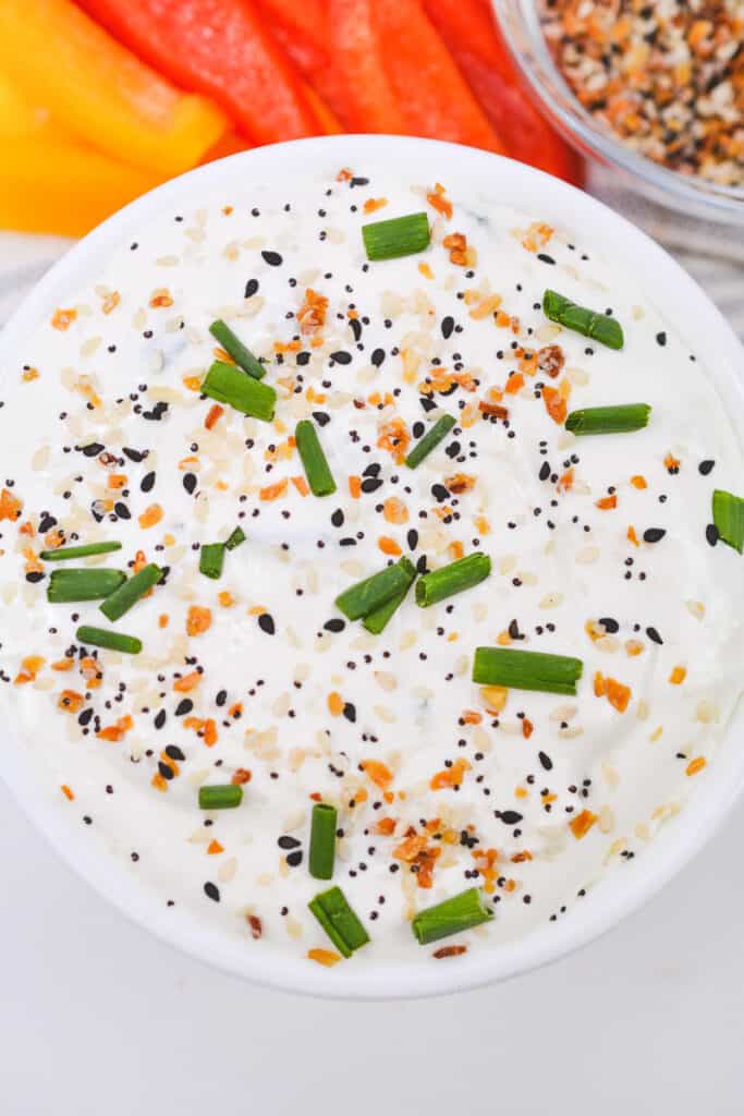 overhead photo of everything bagel dip with everything bagel seasoning and chive