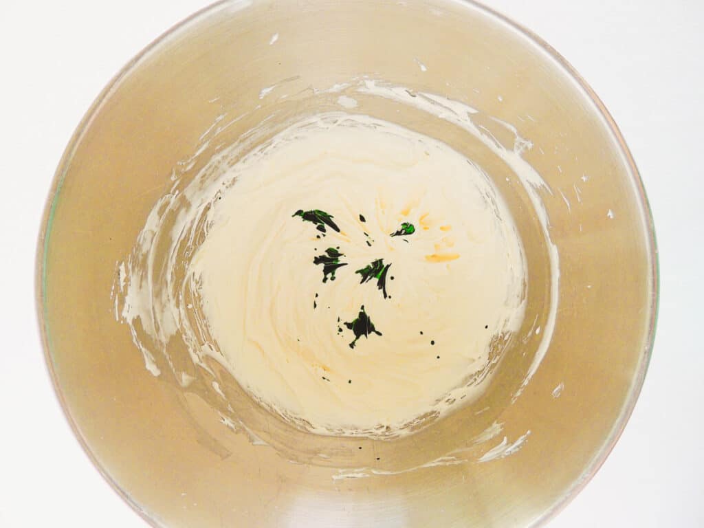 green food coloring on top of marshmallow fluff and cream cheese