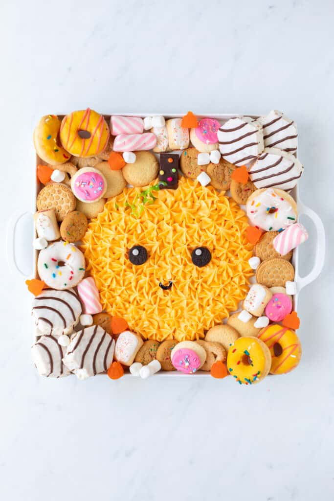 halloween frosting board surrounded by sweet treats
