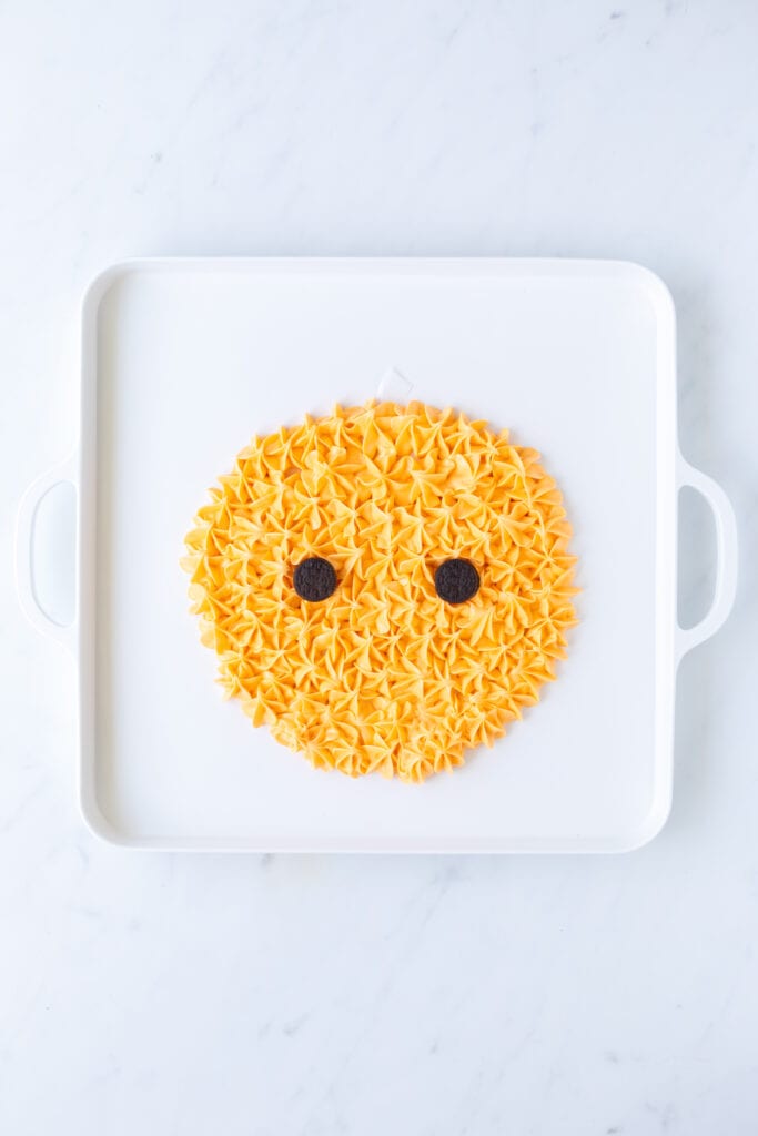 frosting pumpkin with 2 mini oreo eyes