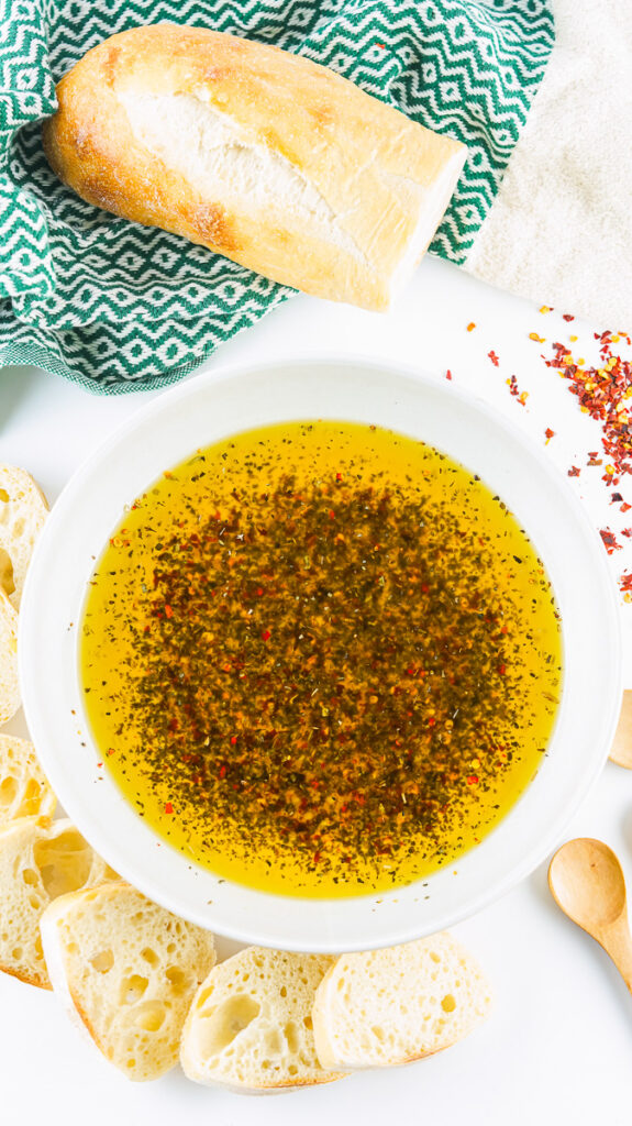 crust bread loaf next to prepared bread dipping oil