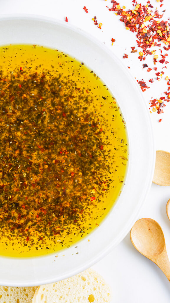 prepared bread dipping oil in a shallow white bowl