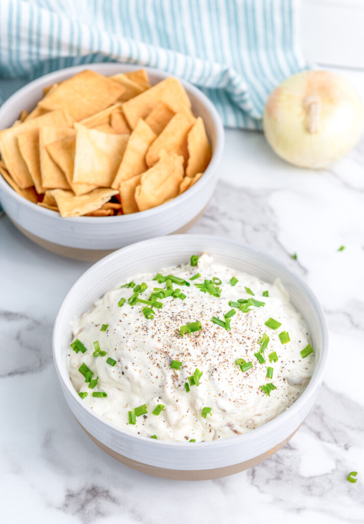 creamy caramelized onion dip in a white bowl ready to eat