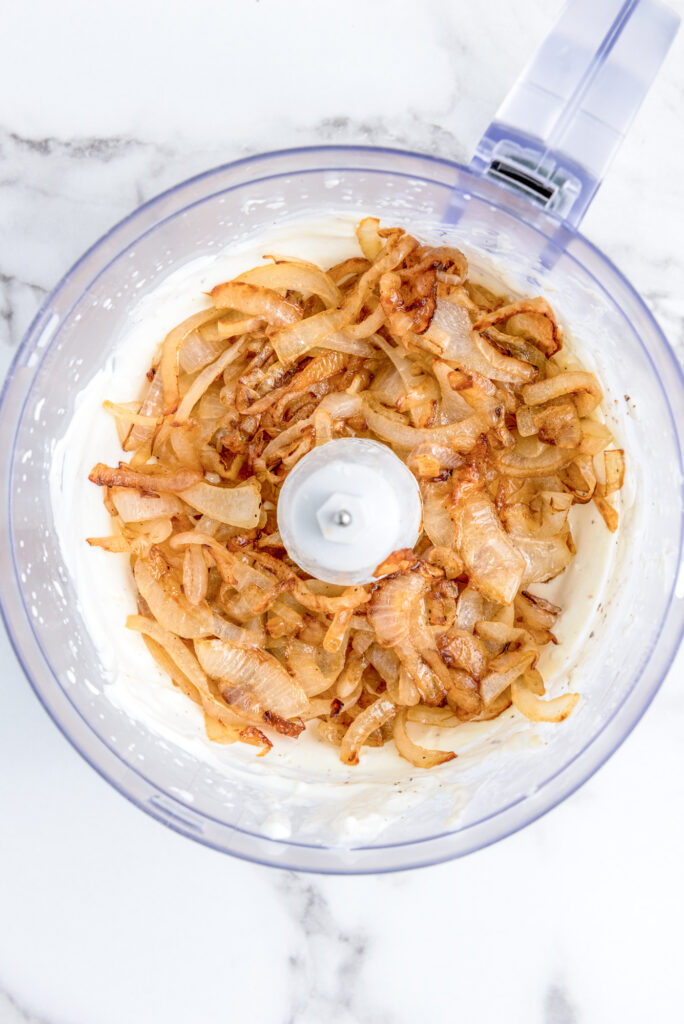 caramelized onions in a food processor with onion dip ingredients