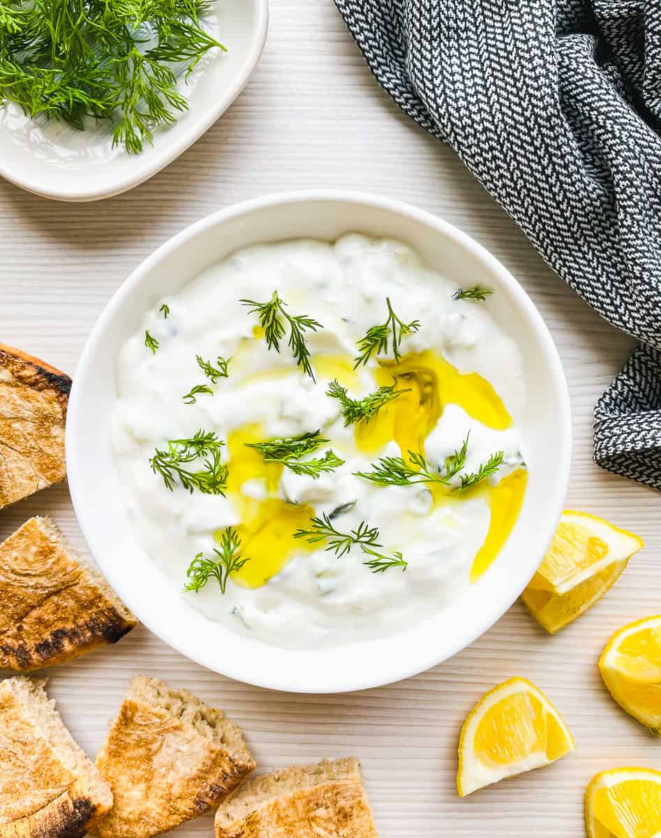 prepared tzatziki with sour cream served with pita bread