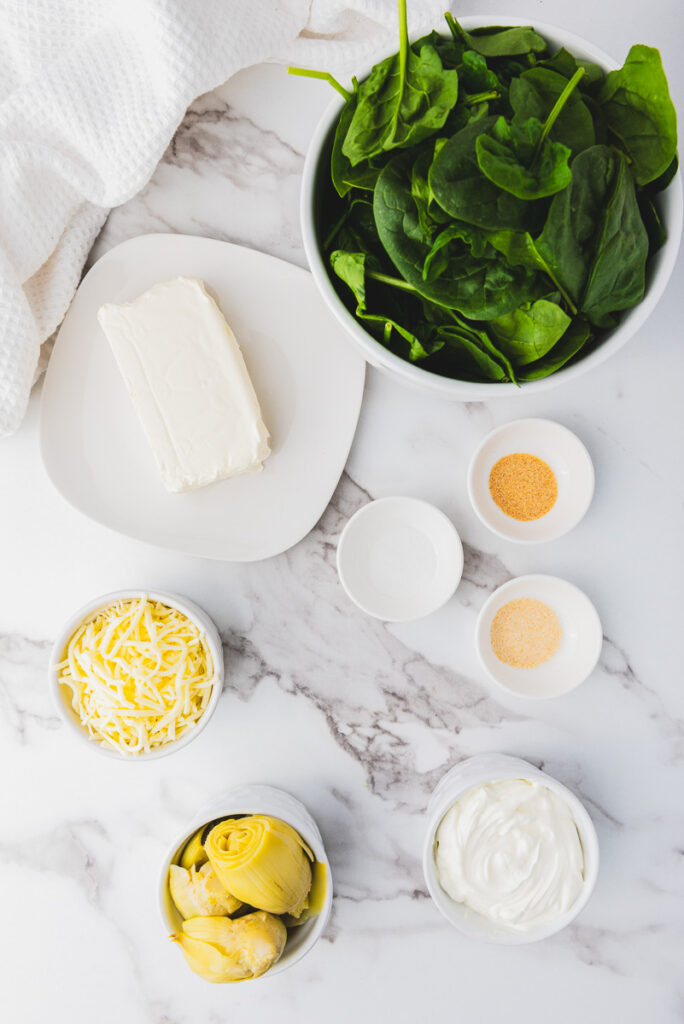 overhead photo of ingredients for crockpot spinach artichoke dip