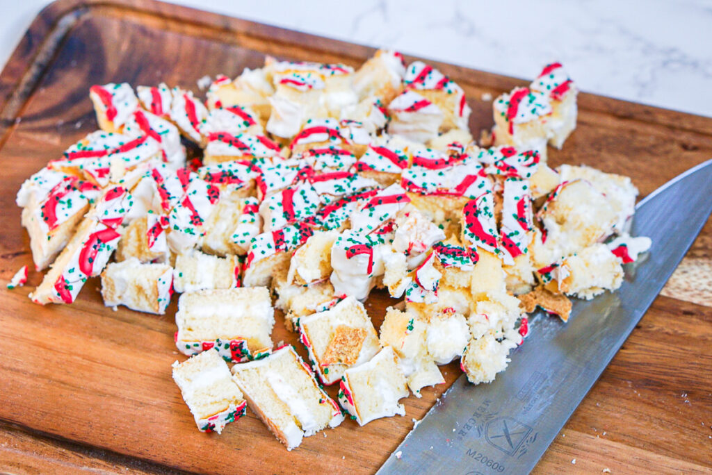 chopped up pieces of little debbie christmas tree cakes on a cutting board