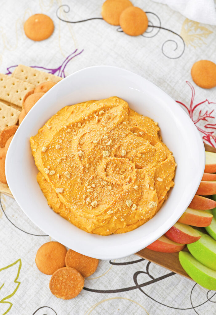 pumpkin pie flavored dip with graham cracker garnish and cookie and apple dippers 