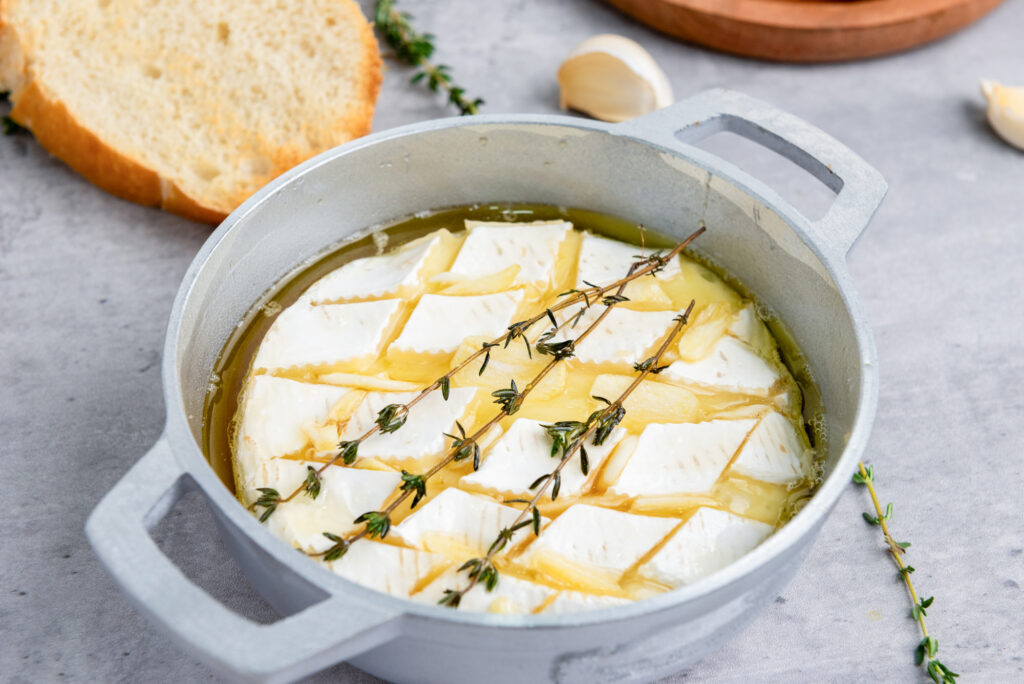 baked brie dip with honey and sprigs of rosemary