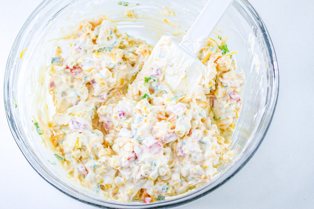 corn, red bell peppers, green onions and shredded cheese folded into cream cheese and may mixture