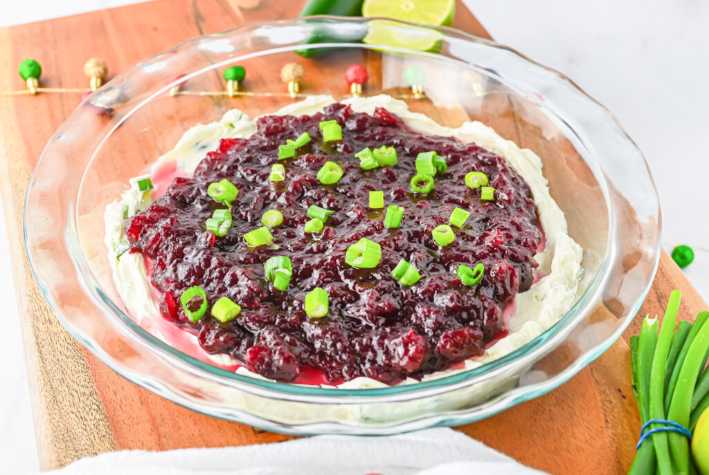 Prepared craberry jalapeno cream cheese dip in a clear pie plate