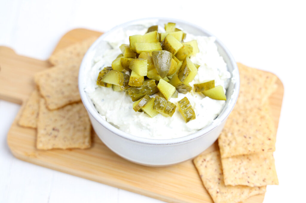 dip with diced pickles on tiop with crackers on the side for dipping