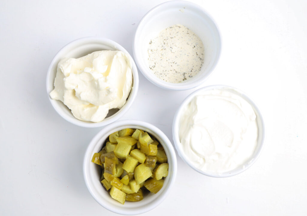 chopped dill pickles, sour cream, cream cheese and ranch seasoning in ramekins 