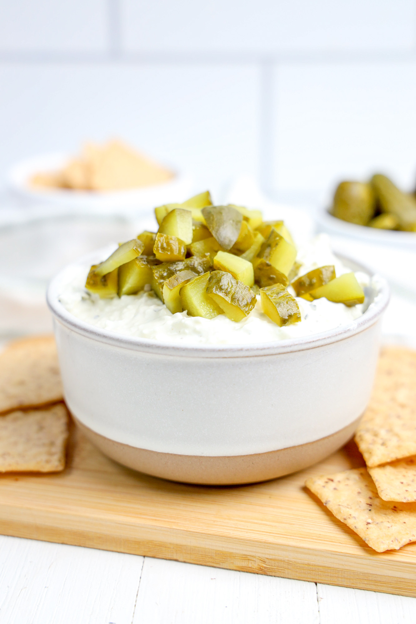 cold dill pickle dip in a small bowl with crackers on the side