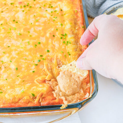 finished texas trash dip with tortilla chip dipper