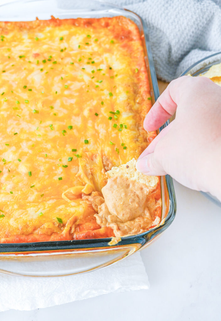 finished texas trash dip with tortilla chip dipper