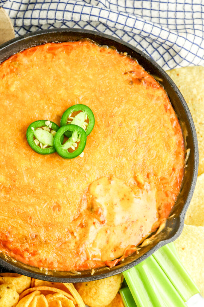 prepared velveeta chili cheese dip in a cast iron skillet with jalapeno garnish