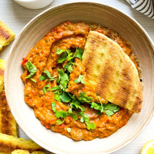 close up of zaalouk with pita dipper