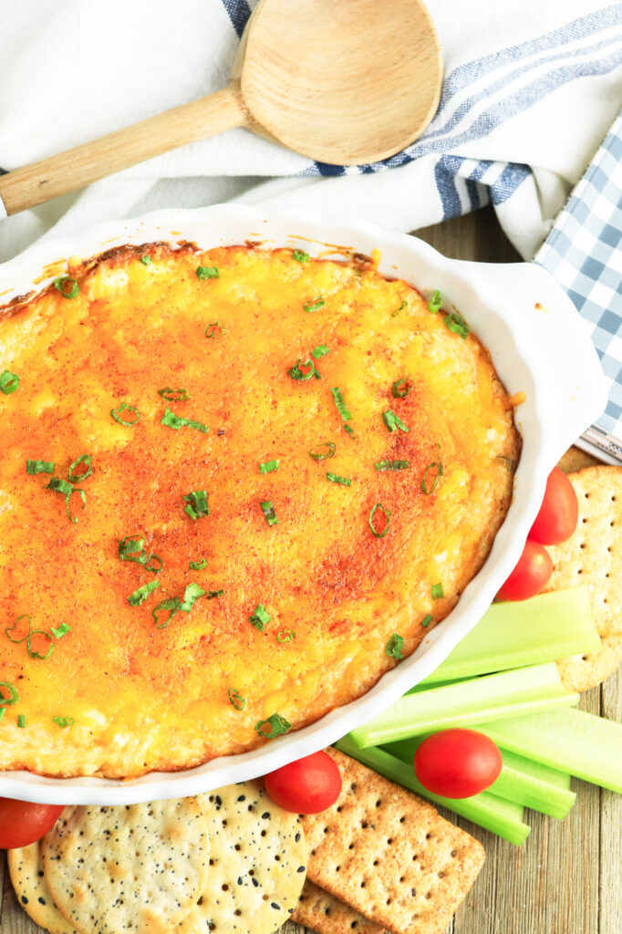 fully prepared hot cajun crab dip with crackers and veggies on the side ready for serving