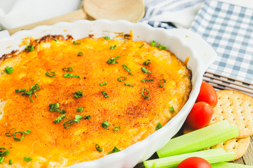 warm crab dip with green onion garnish out of the oven