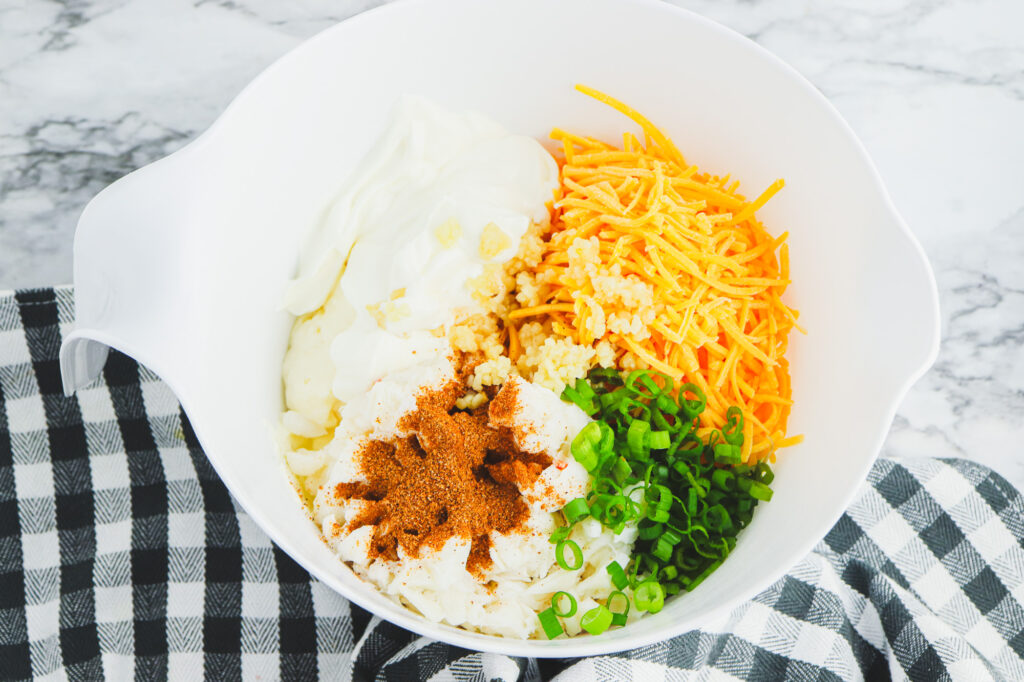 creole crab dip ingredients in a bowl ready for mixing