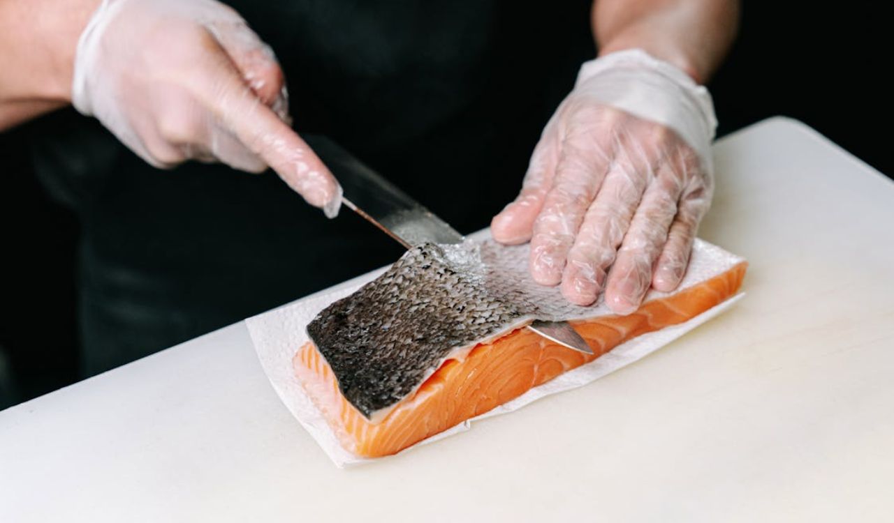A Person Skinning a Salmon