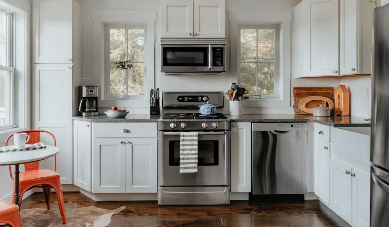 A kitchen with cabinets and ovens