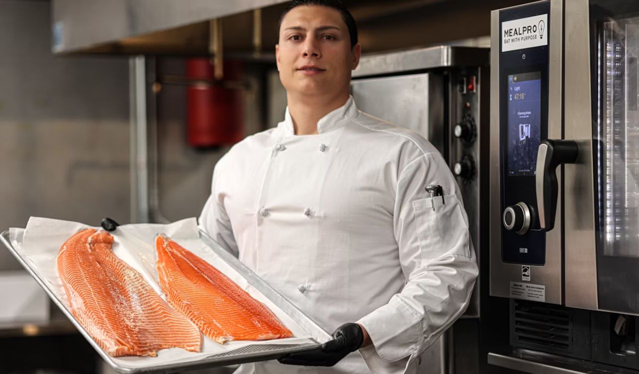 A man holding a tray of salmon